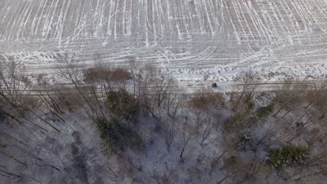 Father-with-Child-Riding-an-ATV-Near-the-Forest-in-Winter-1