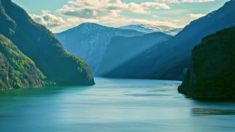 Timelapse-of-clouds-moving-over-fjord-in-Norway-and-ferryboat-cruising