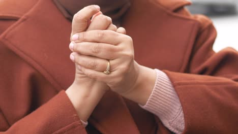 woman's hands clasped together