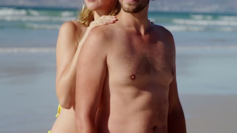 Couple-standing-together-at-beach