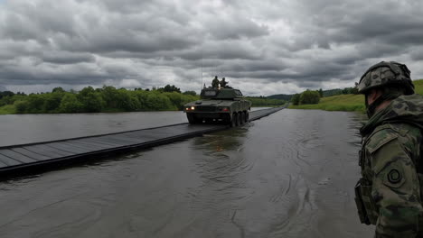 military vehicle crossing flooded river