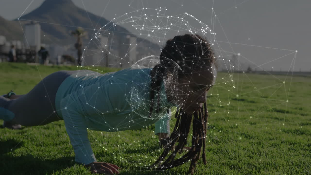 Woman performing push-up in waterfront park, showing fitness tech overlay tracking biometric data