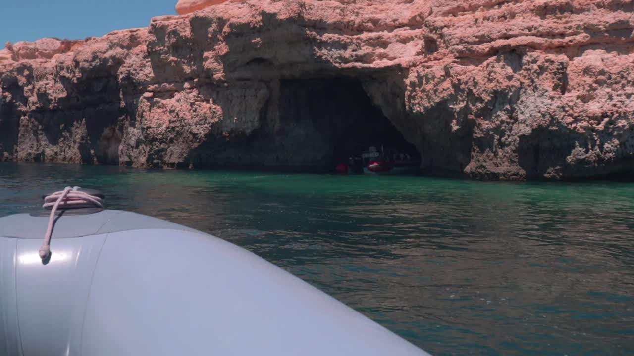 Point Of View From Speedboat Sailing To Cave On Sea