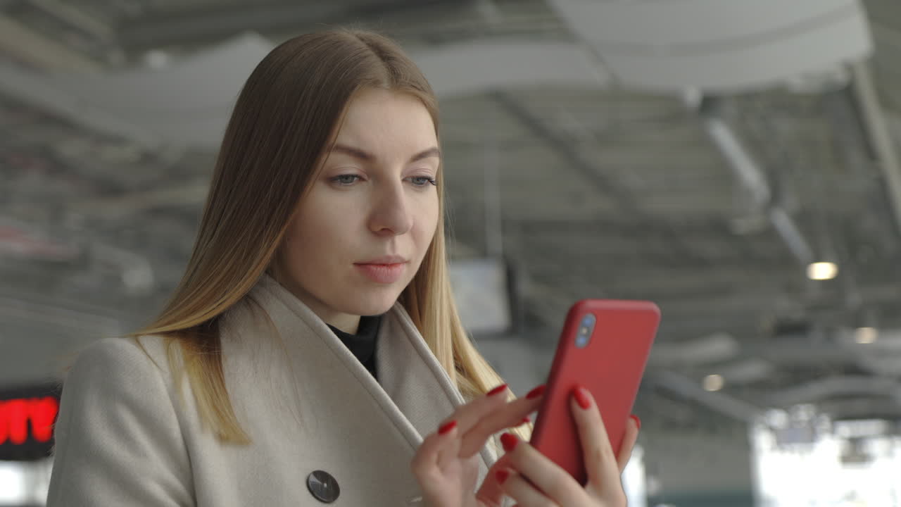 Woman using smartphone in modern building