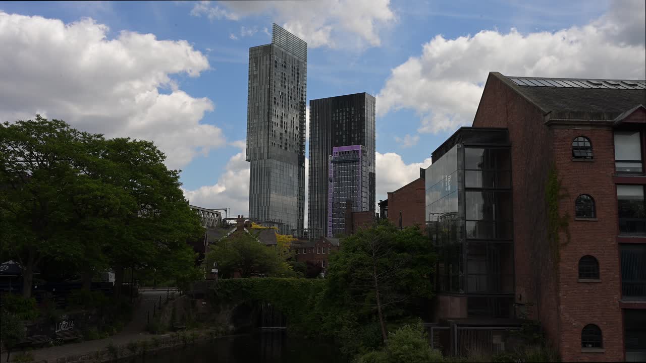 Hilton Tower (Beetham Tower) seen from the canal basin in Castlefield, a unique perspective of Manchester's vibrant cityscape and blends modern architecture with historic waterways.