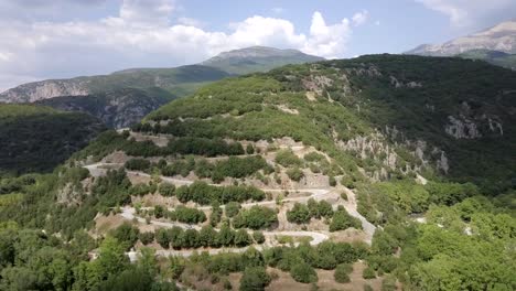 Winding-road-to-Papingo,-Greece-near-a-river-valley