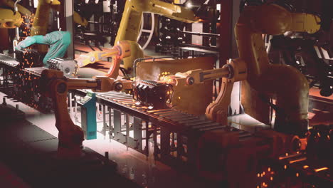 automated car engine assembly line with robots and human worker