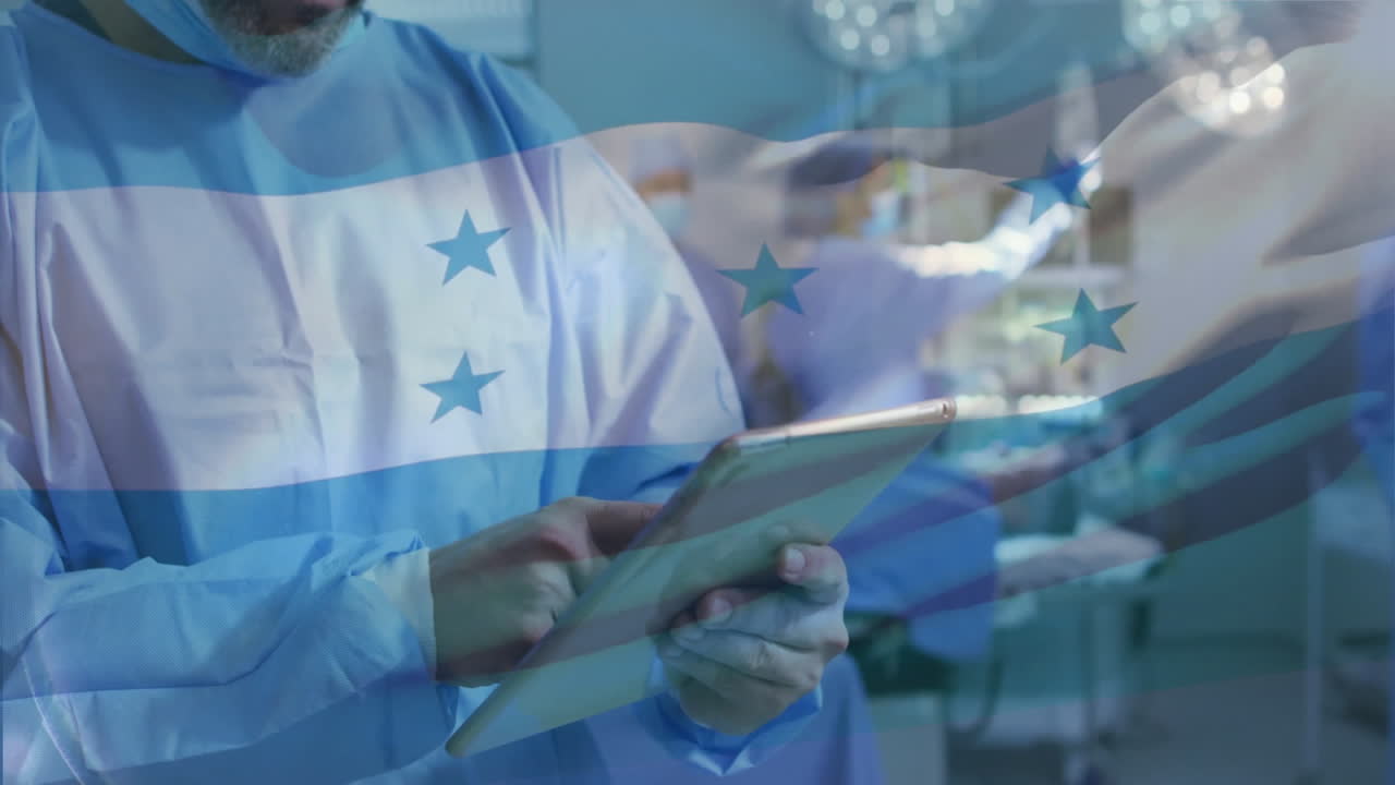 Animation of flag of honduras over african american male surgeon using tablet in hospital