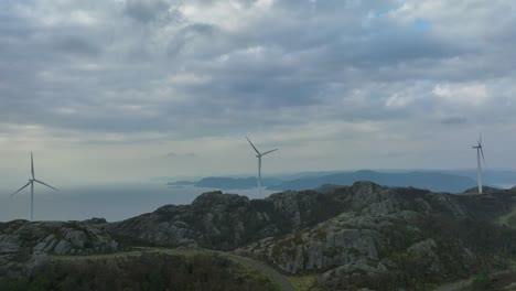 wind turbines rotate steadily in coastal winds at lista park