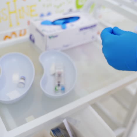 doctor prepares medical instruments. hands in blue gloves of a nurse preparing syringe for injection in clinic. medical concept.