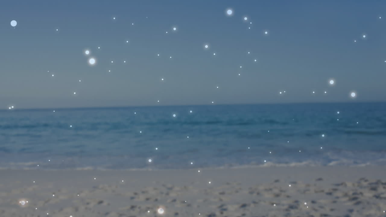 Sparkling lights creating animation over serene beach and ocean scene at sunset