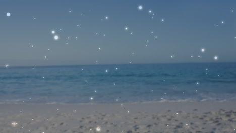 sparkling lights creating animation over serene beach and ocean scene at sunset