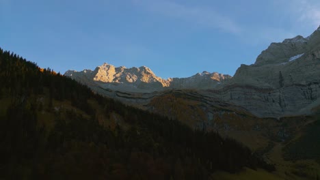 Parallax-alps-mountain-peaks-in-Austria-Bavaria-with-romantic-and-scenic-green-grass-meadows-and-maple-trees-in-natural-landscape