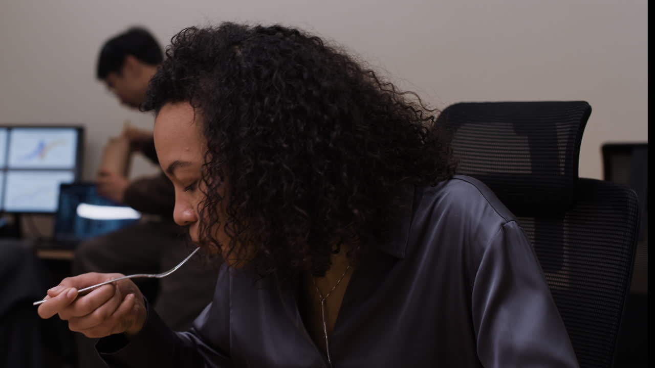 Woman Eating Lunch in Office
