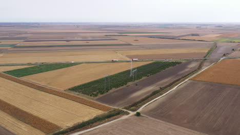 traffic on the road through cultivated countryside landscape, aerial shot