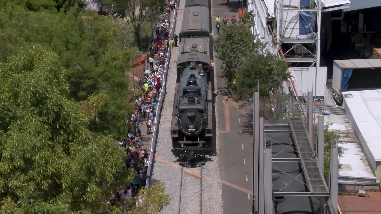 Steam Train Arriving at Station with Crowd of Spectators