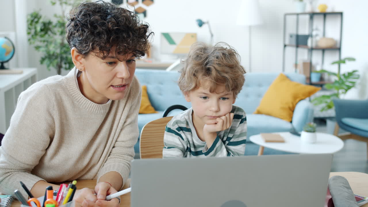 Mother helping child with online learning
