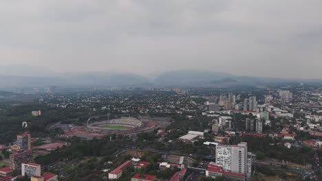aerial shot of south cdmx, olympic university stadium in distance