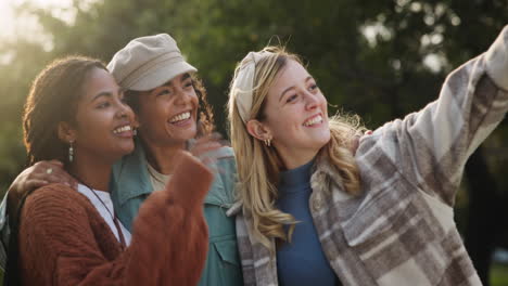 three smiling women taking a selfie outdoors