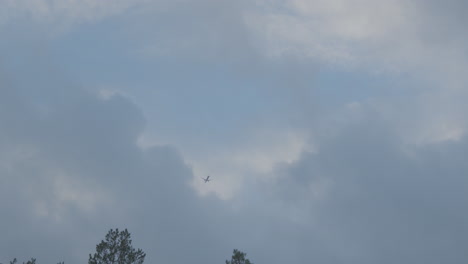 Plane-hiding-behind-clouds,-view-from-the-ground