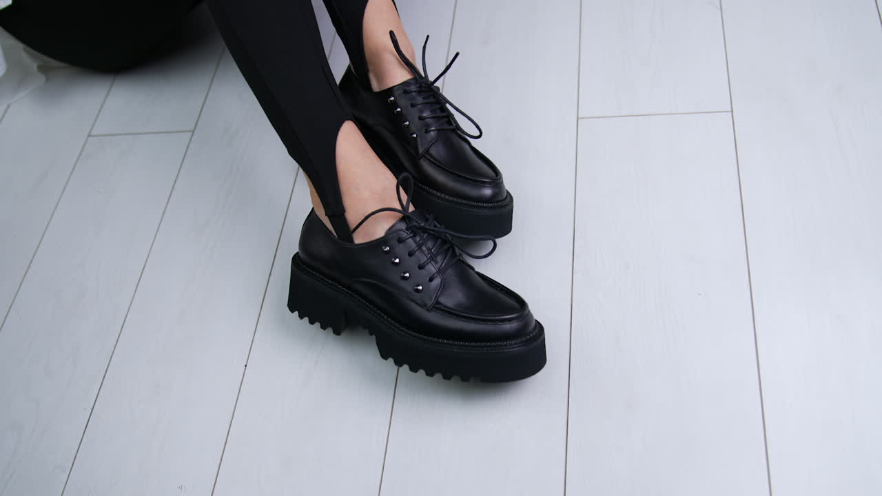 Black Platform Lace-up Shoes on Woman's Feet