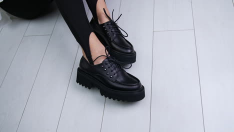 black platform lace-up shoes on woman's feet