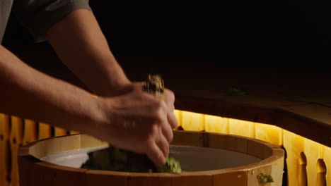 preparing a traditional russian sauna with herbal branches