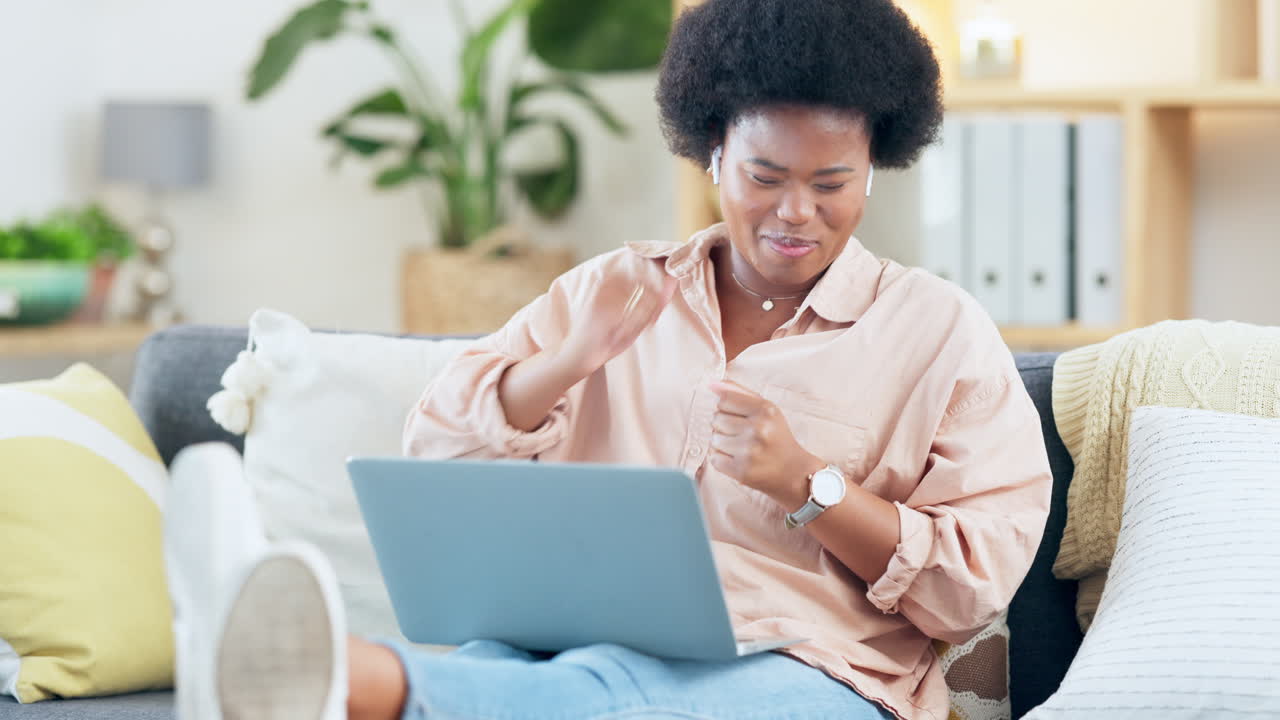 Woman enjoying music on a laptop
