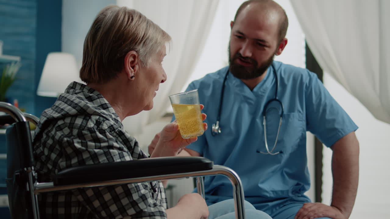 Medical assistant giving glass with effervescent vitamin to patient