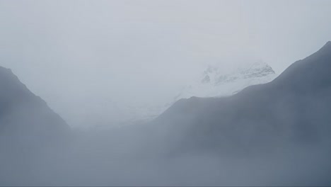 minimalist misty mountain scenery, snowcapped mountains in mist in minimalist landscape and nature shot in the himalayas mountains in nepal