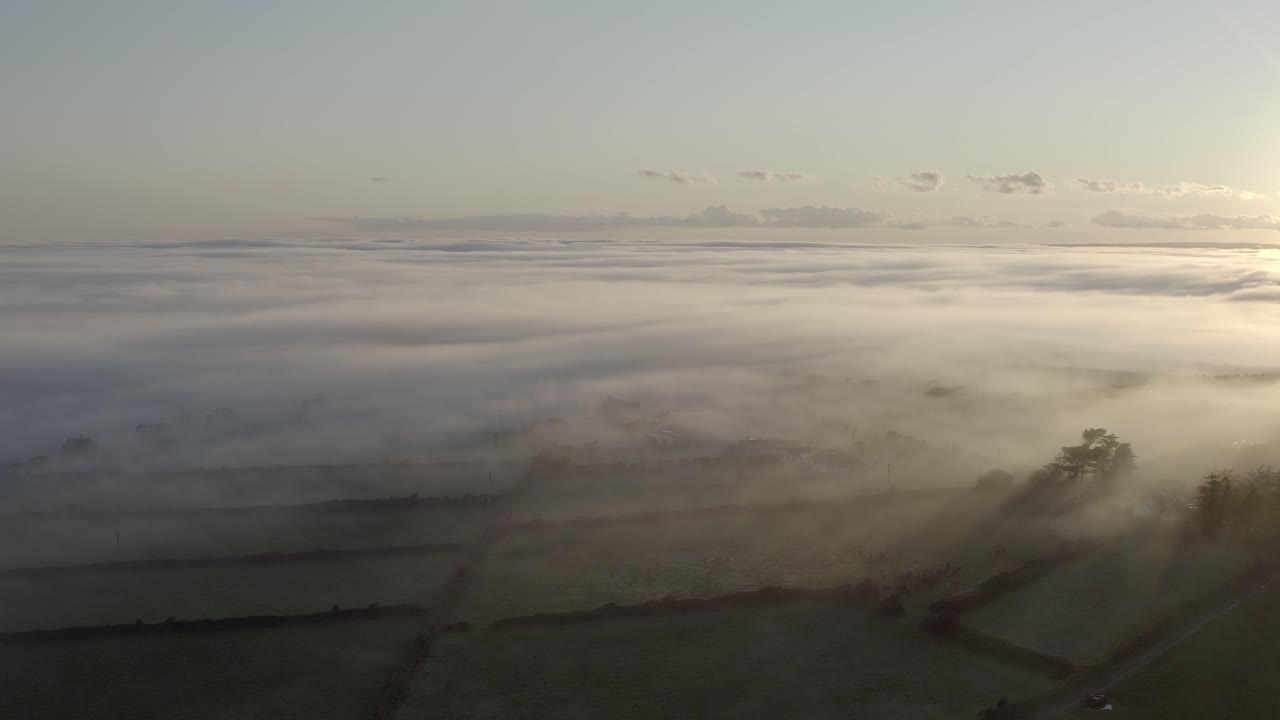 Ethereal countryside aerial of foggy sunrise over agricultural farms