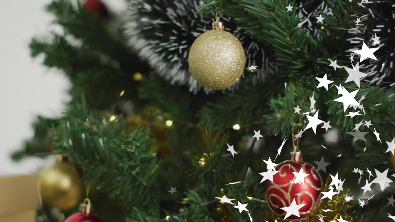 Animation of stars falling over christmas decorations and tree background