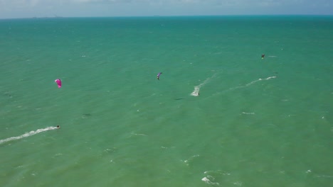 aerial: cumbuco during day with people kitesurfing