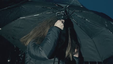 girl-holds-umbrella-enjoying-rain-in-evening-slow-motion