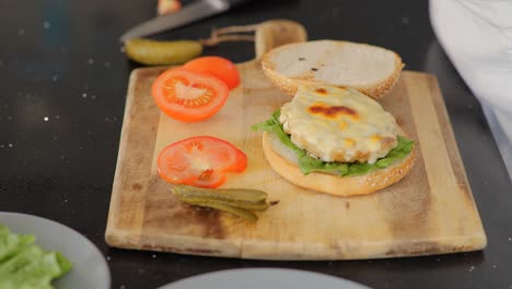 Close-up-of-assembling-a-freshly-grilled-chicken-burger-and-adding-ketchup