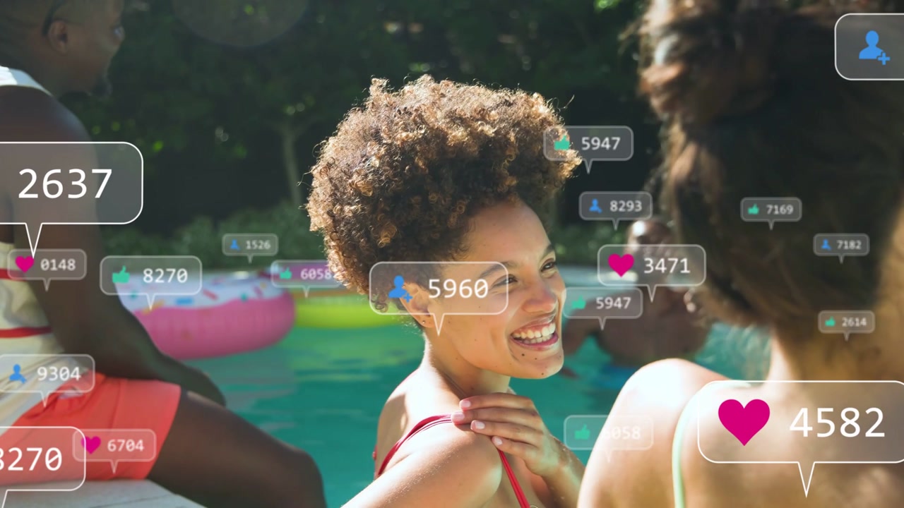 Curly-haired woman leaning poolside turning laughing, sparking social hearts showing rising buzz