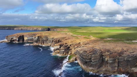 drone shot of yesnaby cliff and vista point on coastline of orkney, scotland uk on sunny day