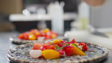 hand of chef dressing salad with lemon juice