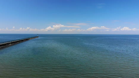 drone footage of a long pier and lake huron near caseville, michigan