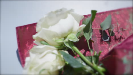 White-Roses-on-a-red-silk-backdrop