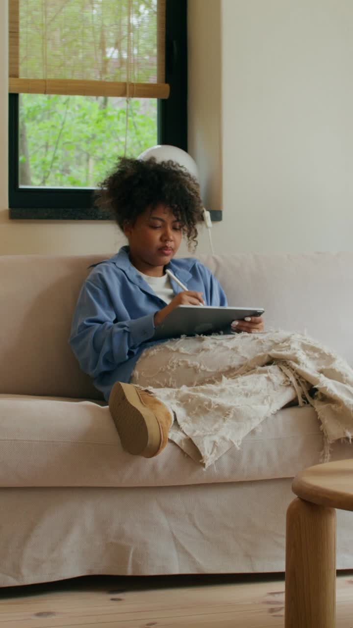 Woman Drawing on a Tablet at Home