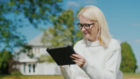 Woman-Uses-Tablet-by-Suburban-Home