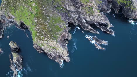 drone video flying upwards while shooting top down at slieve league, ireland at sunset