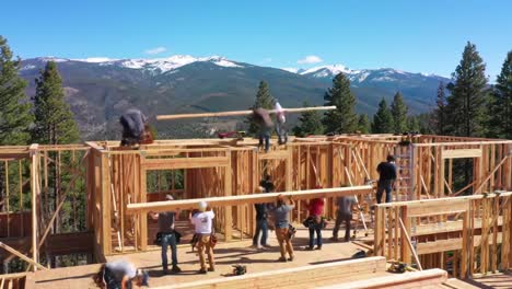 a team works together to construct a wooden structure in a mountainous region.