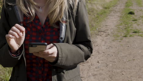 woman using phone on path