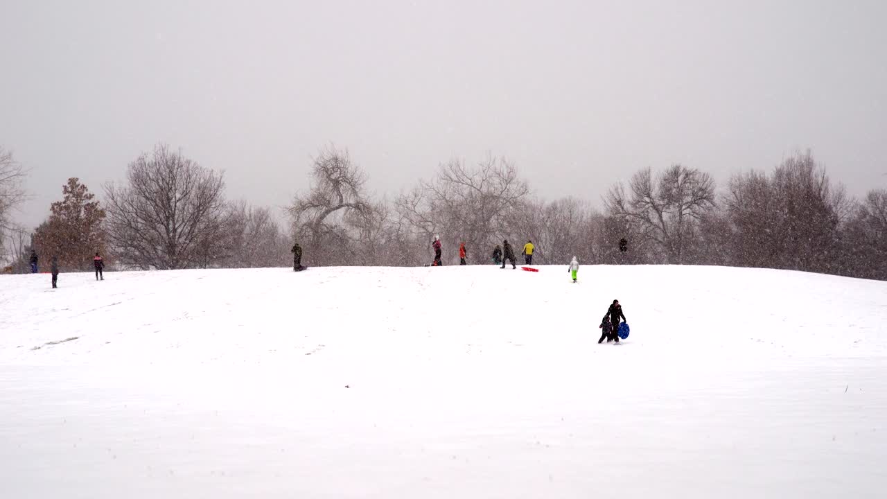 눈 오는 날씨에 공원에서 노는 사람들