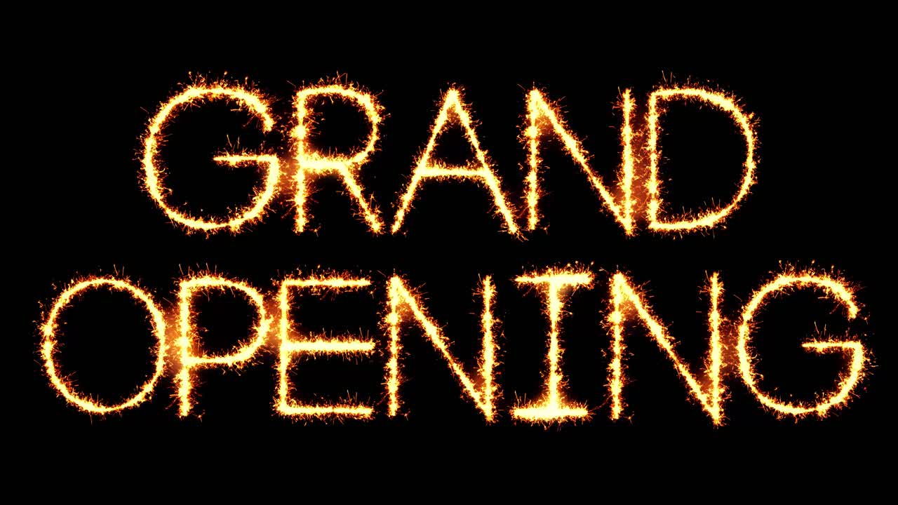 Grand opening text sparkler writing with glitter sparks particles firework on black 4k loop