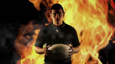 tough rugby player holding ball