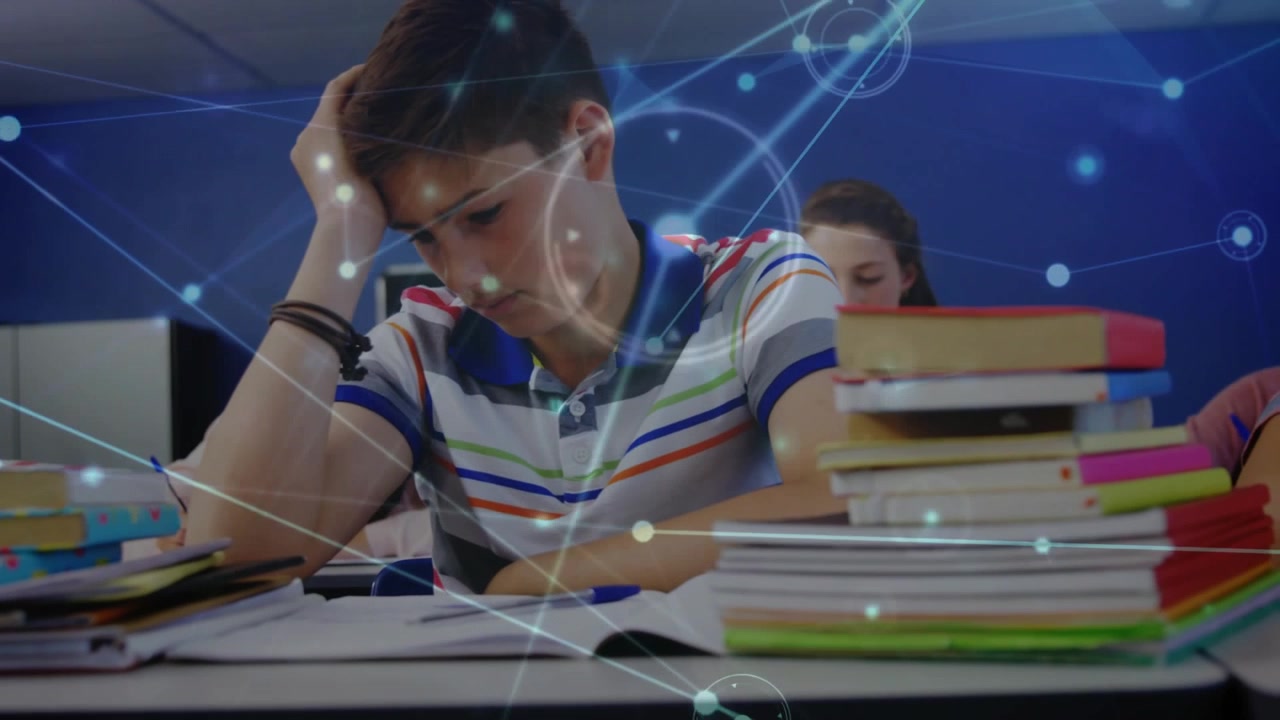 Teenage boy studying, girl reading in school while digital network overlay fading in linking books