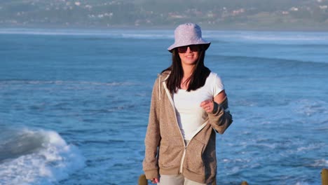 beautiful girl portrait with bucket hat on the beach, pichilemu, punta de lobos